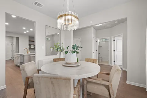 a living room with furniture and a view of kitchen