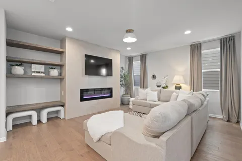 a living room with furniture a fireplace and a flat screen tv