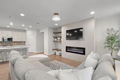 a living room with furniture a fireplace and a flat screen tv