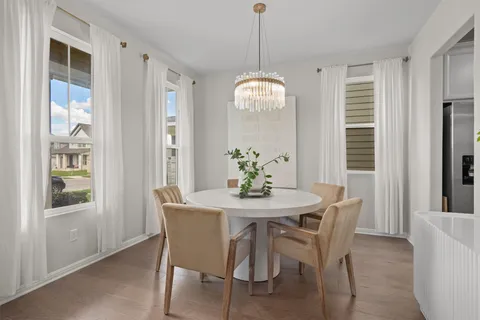 a dining room with furniture and chandelier