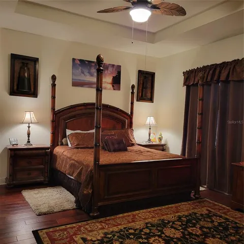a bedroom with a bed and a lamp on dresser