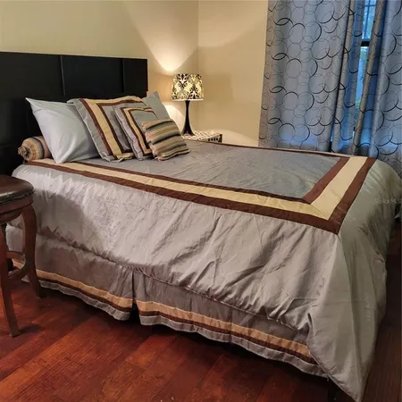 a bed sitting in a bedroom next to a brick wall