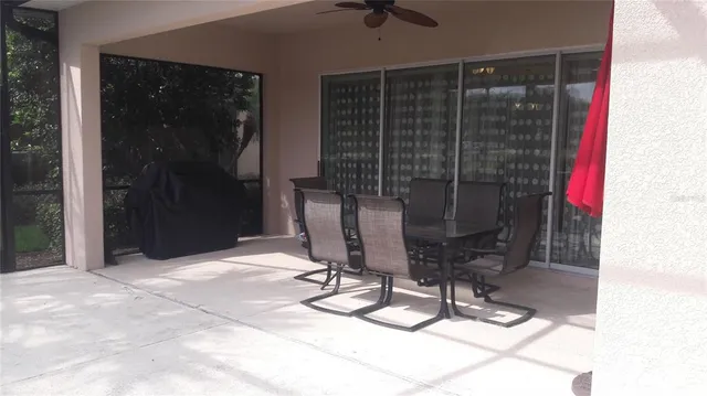 a dining room with glass top table and chairs