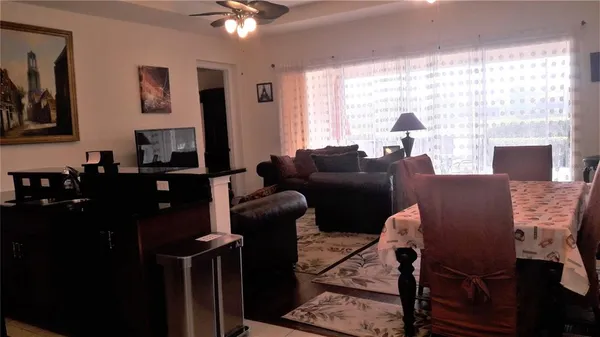 a living room with furniture a large window and a flat screen tv