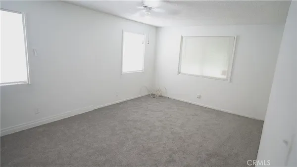 a view of an empty room with a fan