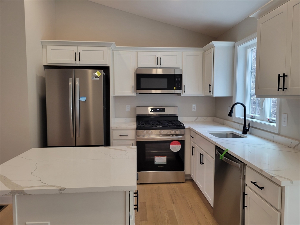 741 Chestnut Street Athol, MA 01331 - Photo 2 of 13 a kitchen with a sink a stove and refrigerator