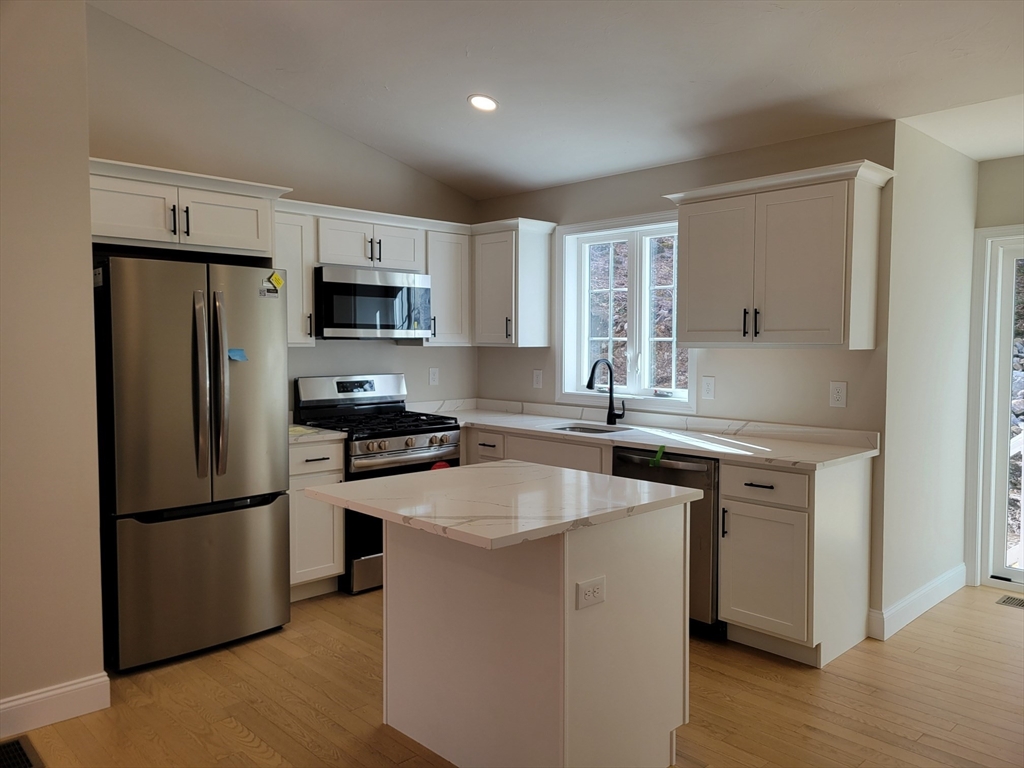741 Chestnut Street Athol, MA 01331 - Photo 3 of 13 a kitchen with stainless steel appliances granite countertop a refrigerator a stove a sink and a microwave