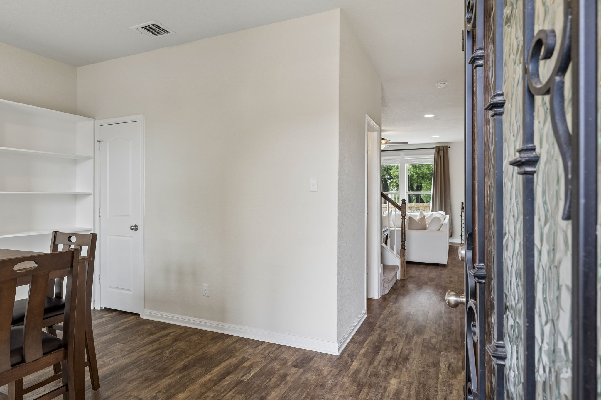 809 Whitman Avenue Georgetown, TX 78626 - Photo 7 of 35 a view of a hallway with wooden floor and a bathroom