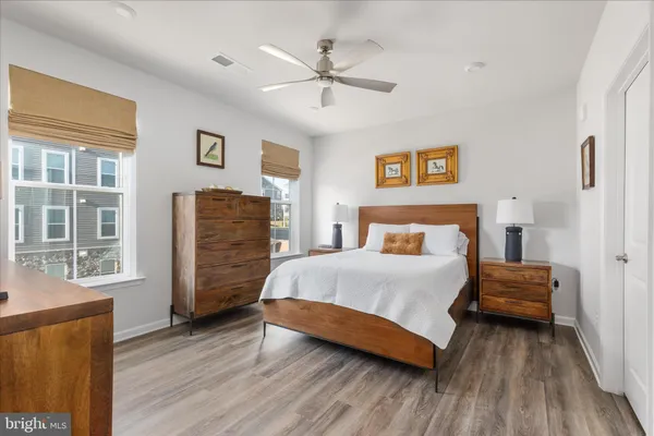 a bedroom with a bed and wooden floor