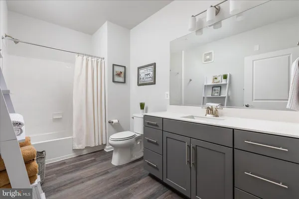 a bathroom with a sink toilet a mirror and shower