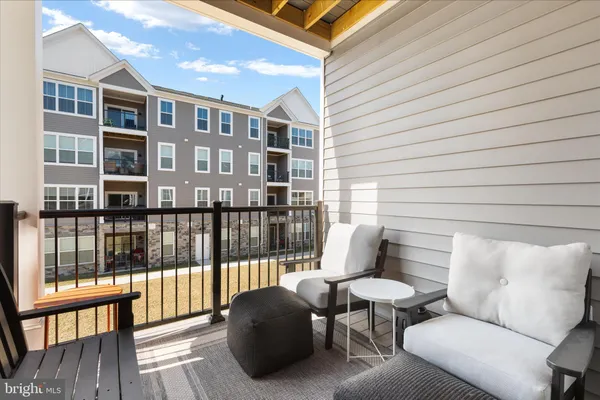 a balcony with furniture and a potted plant