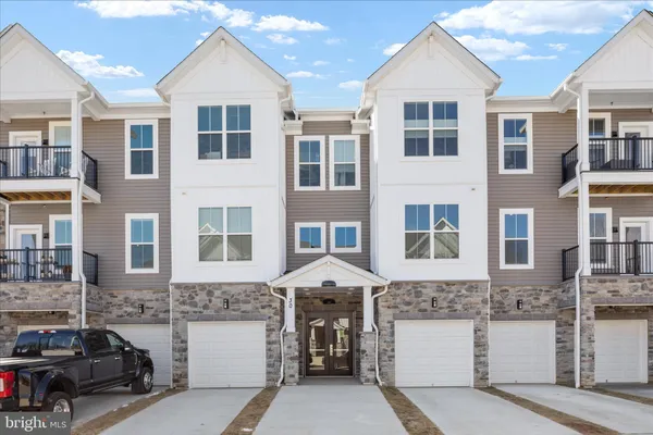 a front view of a residential apartment building with a yard