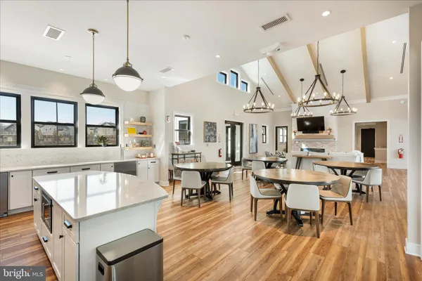 a large kitchen with kitchen island a large window