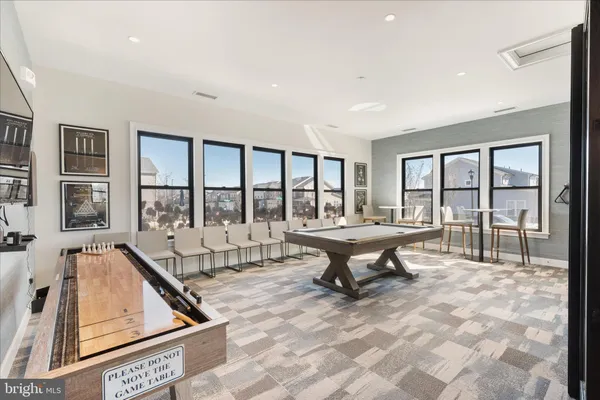 a very nice looking living room with a dining table chairs with wooden floor