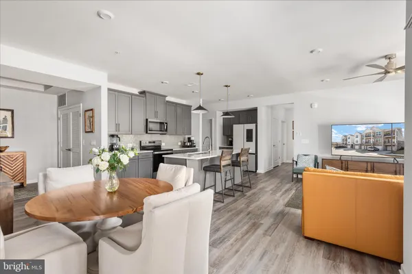 a view of a dining room with furniture and wooden floor