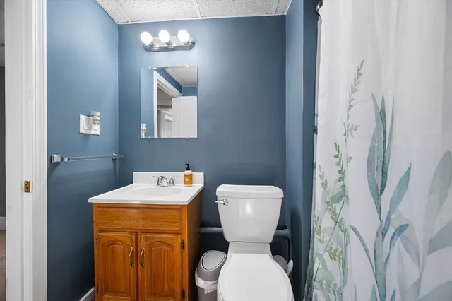 a bathroom with a toilet sink and mirror