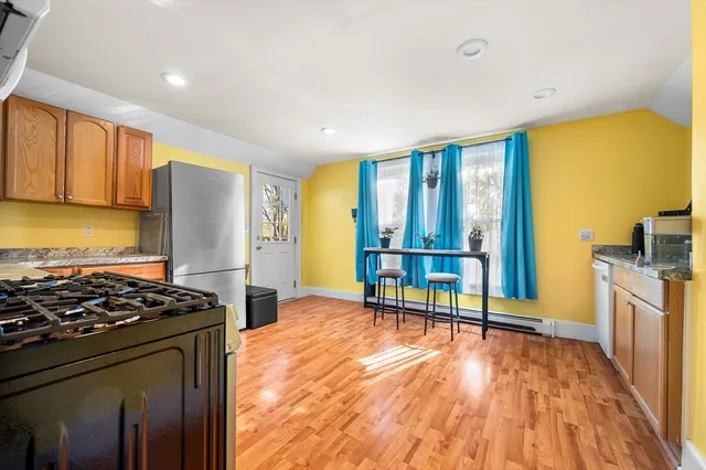 a kitchen with stainless steel appliances granite countertop a stove and a refrigerator