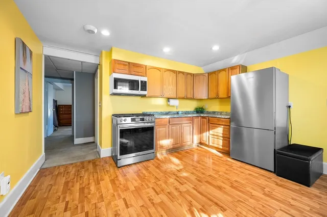 a kitchen with a refrigerator and a stove top oven
