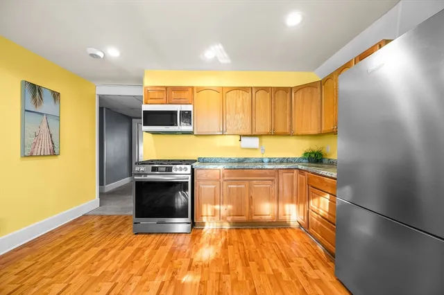 a kitchen with stainless steel appliances a stove a sink and a microwave