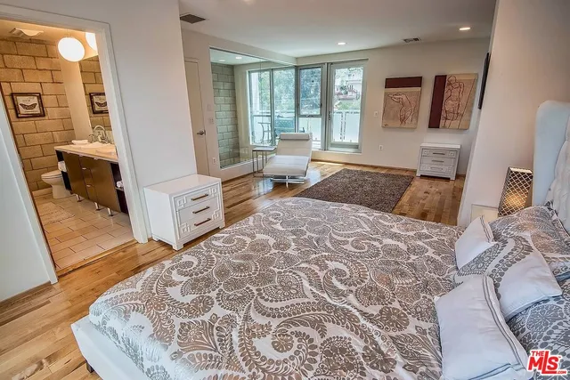 a bedroom with a large bed and a window