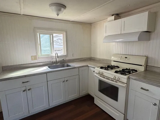 a kitchen with cabinets appliances and a sink