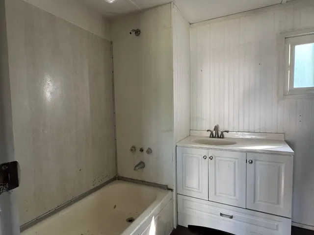 a bathroom with a sink a toilet and vanity
