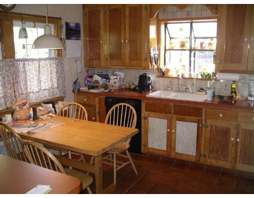194 King Philip Road Worcester, MA 01606 - Photo 2 of 10 a kitchen with a table chairs sink and cabinets
