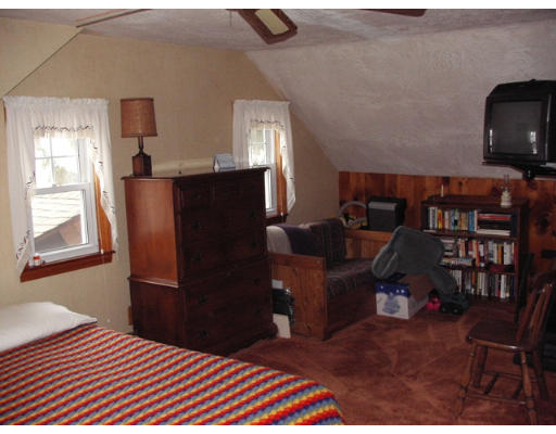 194 King Philip Road Worcester, MA 01606 - Photo 8 of 10 a bedroom with a bed and wooden floor