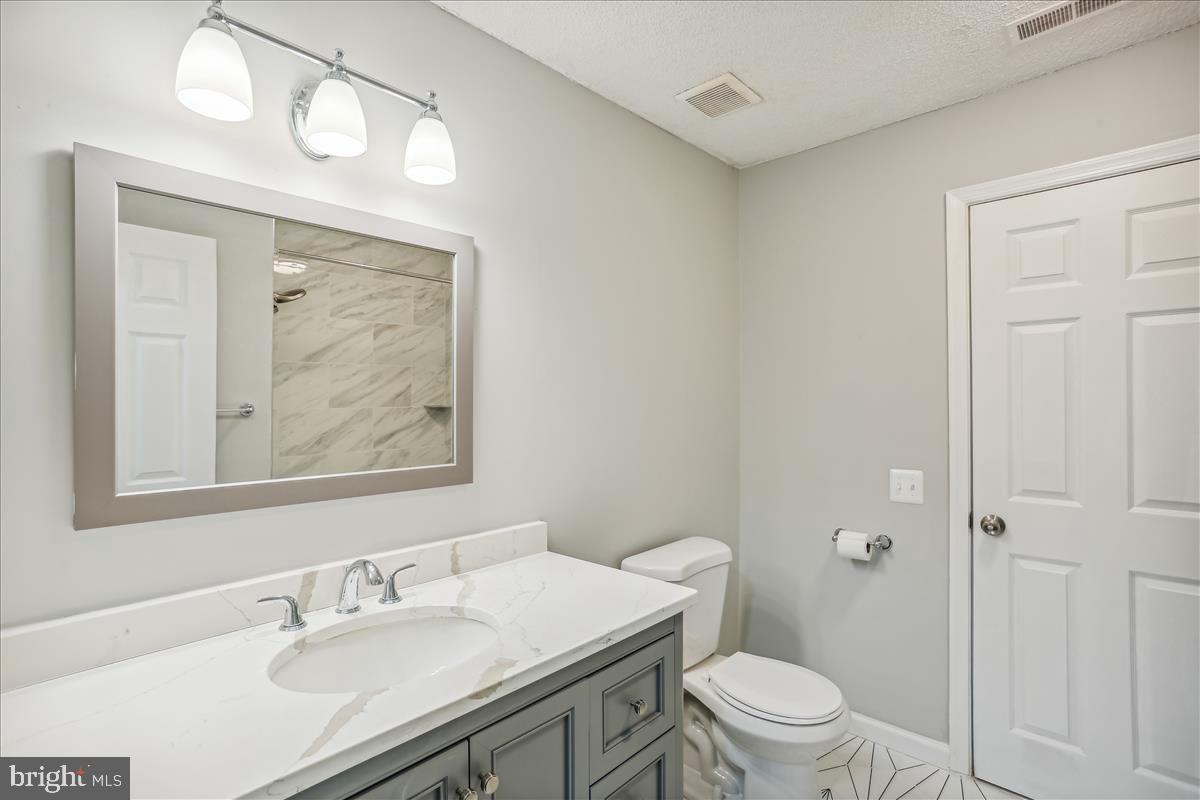 12901 Churchill Ridge Circle, Unit 14 Germantown, MD 20874 - Photo 11 of 46 a bathroom with a sink vanity mirror and toilet