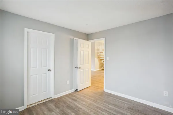 a view of an empty room and wooden floor