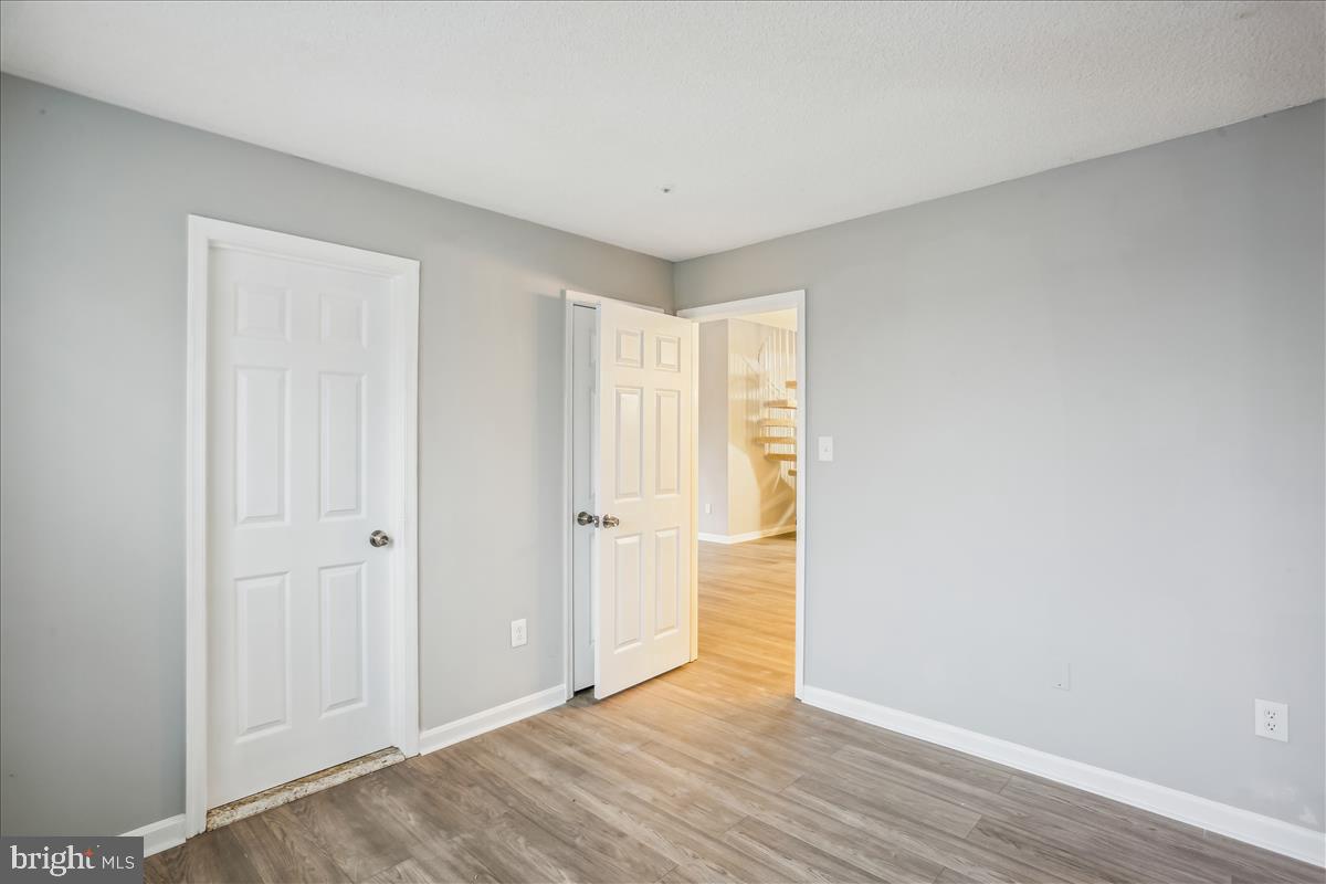 12901 Churchill Ridge Circle, Unit 14 Germantown, MD 20874 - Photo 17 of 46 a view of an empty room and wooden floor