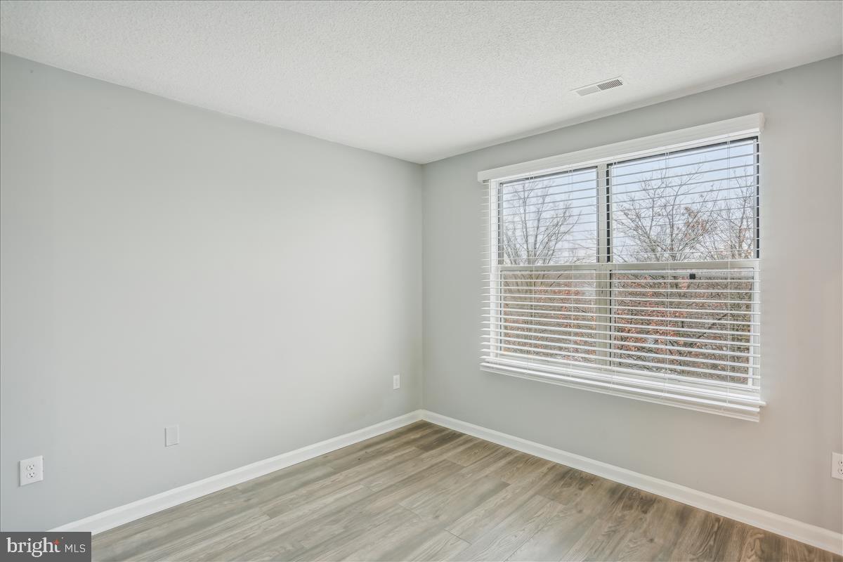 12901 Churchill Ridge Circle, Unit 14 Germantown, MD 20874 - Photo 20 of 46 a view of an empty room with a window