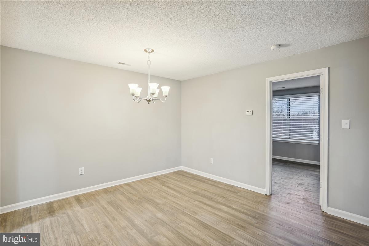 12901 Churchill Ridge Circle, Unit 14 Germantown, MD 20874 - Photo 24 of 46 wooden floor in an empty room