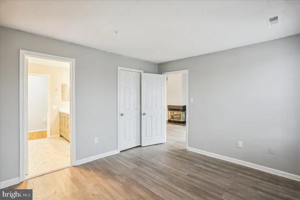 a view of an empty room and wooden floor