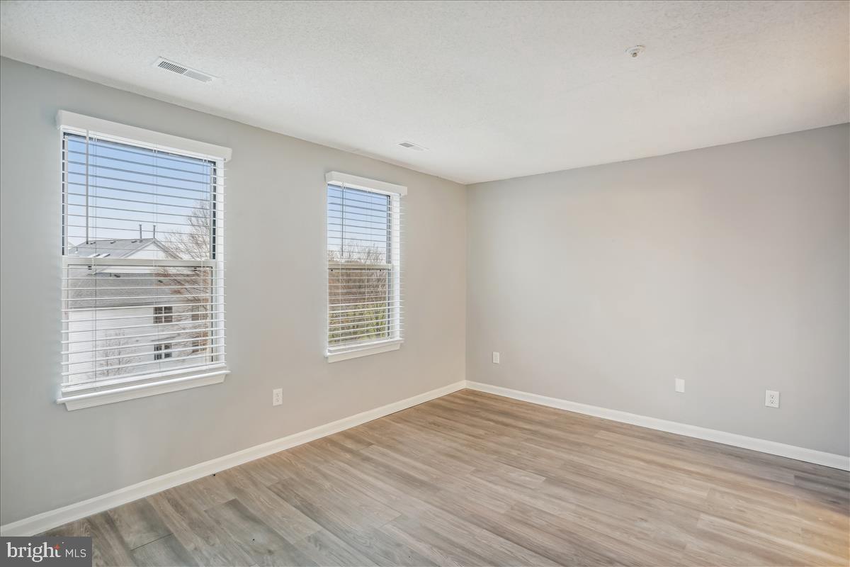 12901 Churchill Ridge Circle, Unit 14 Germantown, MD 20874 - Photo 31 of 46 a view of an empty room with wooden floor and a window