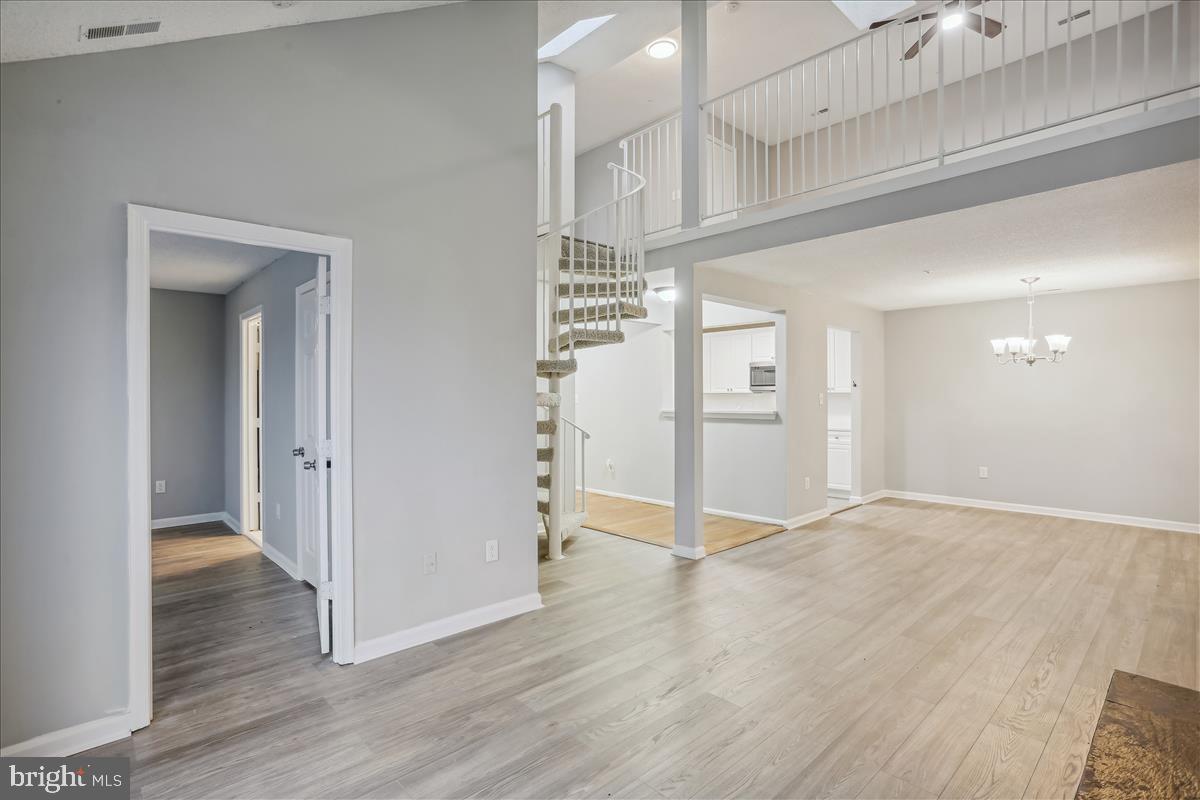 12901 Churchill Ridge Circle, Unit 14 Germantown, MD 20874 - Photo 4 of 46 wooden floor in an empty room with a window