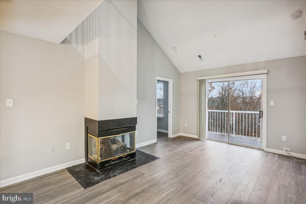 12901 Churchill Ridge Circle, Unit 14 Germantown, MD 20874 - Photo 6 of 46 a view of an empty room with wooden floor and a window