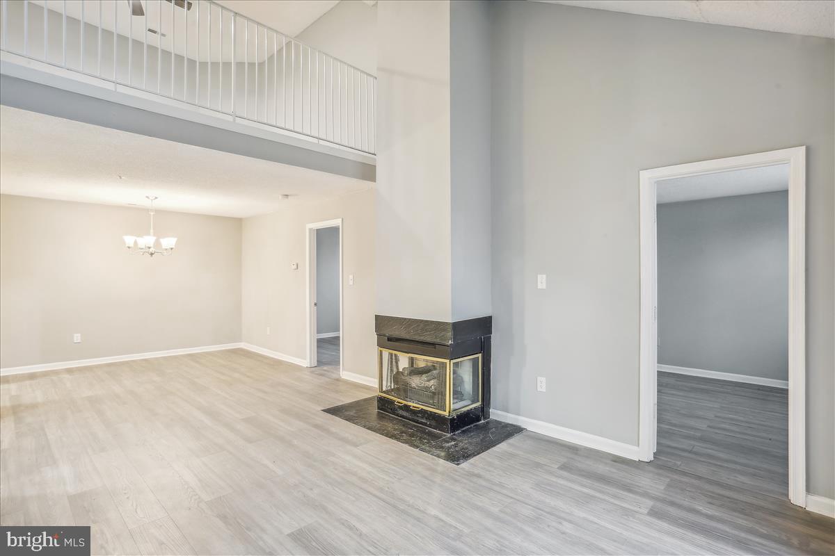 12901 Churchill Ridge Circle, Unit 14 Germantown, MD 20874 - Photo 7 of 46 a view of an empty room with wooden floor and a window
