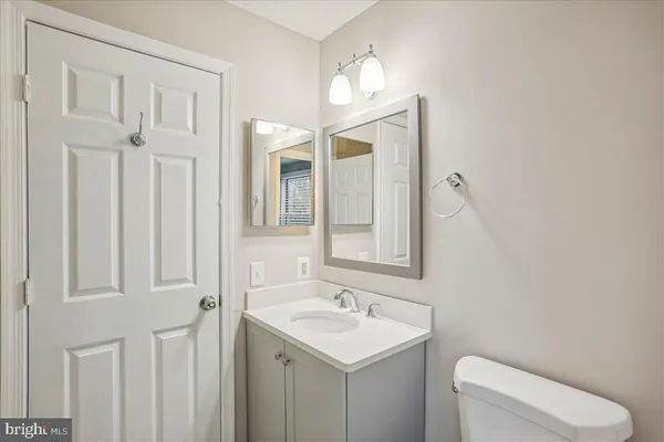 a bathroom with a toilet a sink and mirror