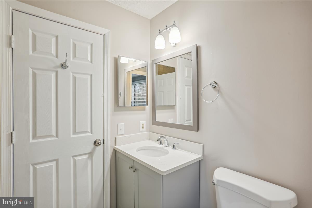 12901 Churchill Ridge Circle, Unit 14 Germantown, MD 20874 - Photo 8 of 46 a bathroom with a toilet a sink and mirror