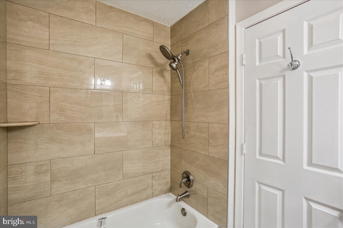 12901 Churchill Ridge Circle, Unit 14 Germantown, MD 20874 - Photo 9 of 46 a bathroom with a bathtub and a shower