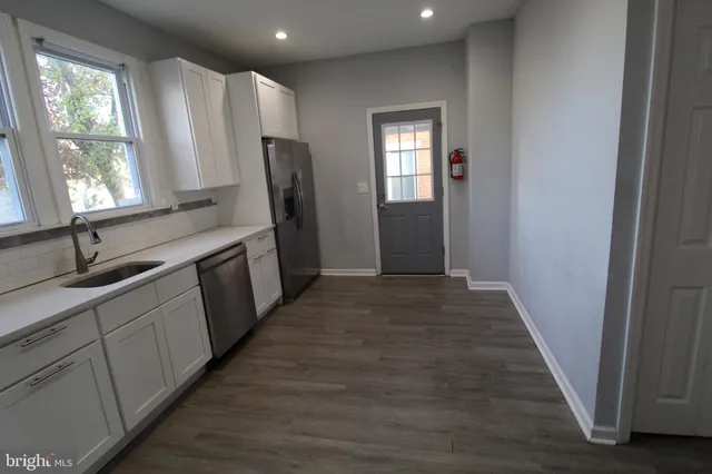 a hallway with windows and chandelier
