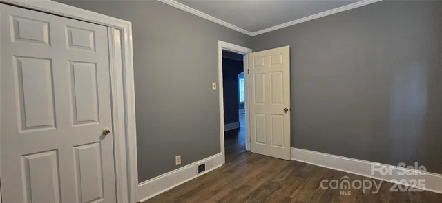 an empty room with wooden floor