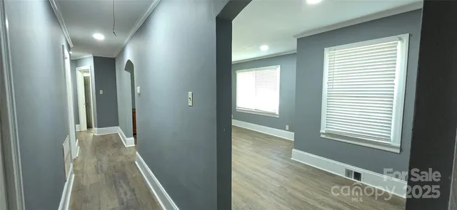 a view of hallway with livingroom and a window