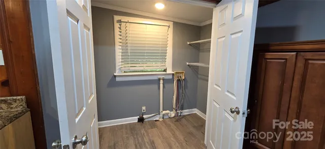 a view of a room with wooden floor and windows