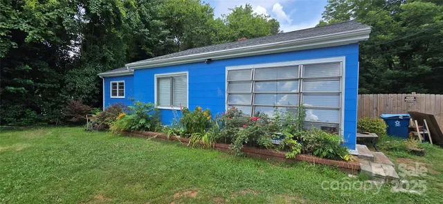 a view of brick house with a yard