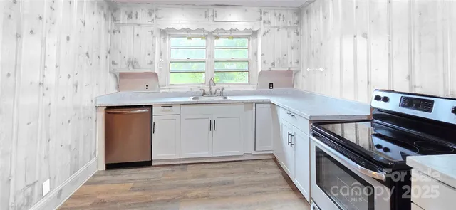 a kitchen with a sink stove and cabinets