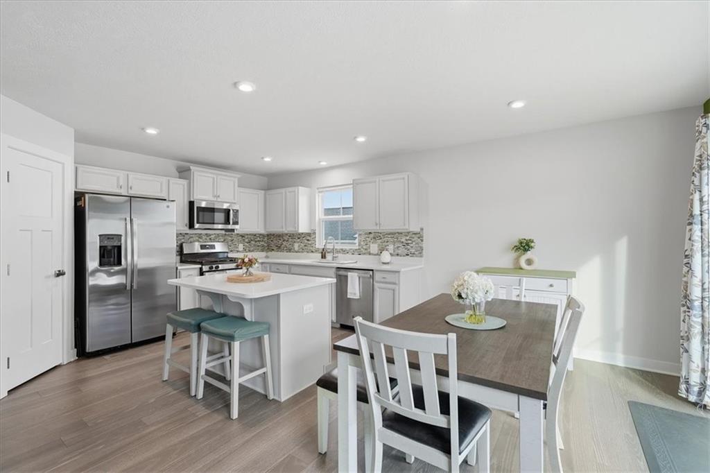 237 Smith Lane Beaver Falls, PA 15010 - Photo 14 of 25 a kitchen with a dining table chairs refrigerator and cabinets