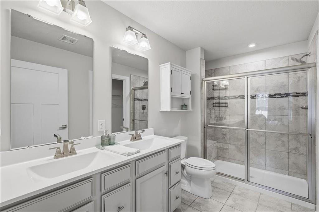237 Smith Lane Beaver Falls, PA 15010 - Photo 19 of 25 a bathroom with a toilet sink a shower and a mirror