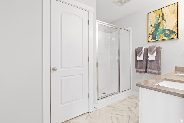 2343 Wysteria Drive Mapleton, UT 84664 - Photo 20 of 30 Bathroom with a shower stall, vanity, and light marble finish flooring